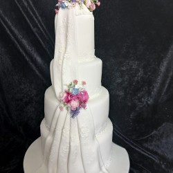 front pink rose draping down wedding cake 